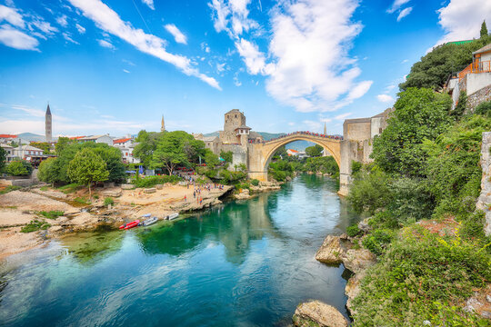 Amazing Skyline of Mostar with the Mostar Bridge, houses and minarets, during sunny day