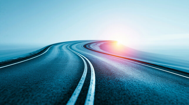 A winding road stretches into the horizon with bright sunlight, symbolizing a journey or new beginnings in a clear, open landscape.
