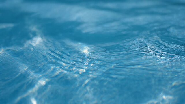 Top-down view of rippling water surface with glowing blue caustic light patterns