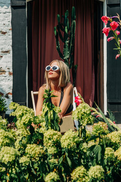 woman in swimsuit lounging in garden during summer heatwave