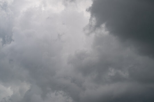 Menacing cloud formations gather quickly. Foreboding atmospheric conditions suggest heavy rainfall. Intense storm clouds rolling in create striking visual for film and ads