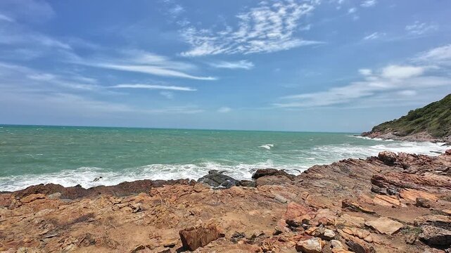 Strong summer winds whip the ocean waves against the rocks.