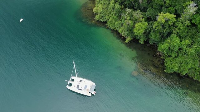 Sailing boat anchored in a calm bay. Ilha Grande, Brazil