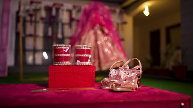 Indian bridal accessories on display. Traditional wedding bangles and footwear for bride.
