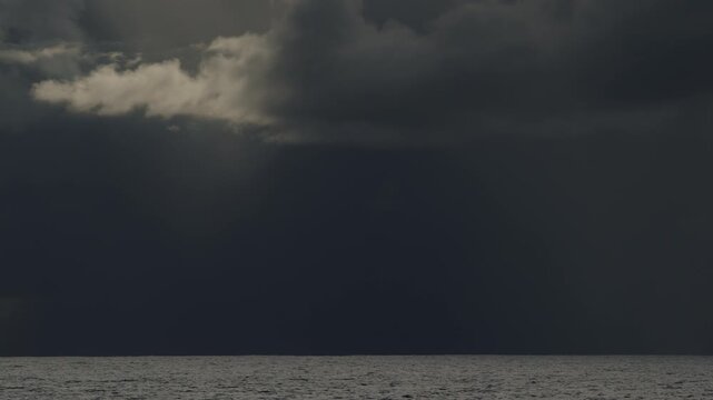Dark Atlantic Ocean and stormy clouds as seen from the moving sailing boat
