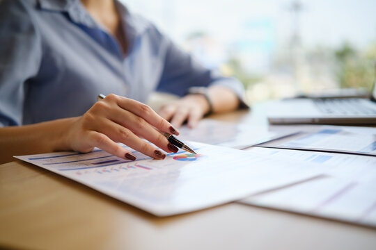 Business analyst examining graphs and statistics, representing financial planning, research, and corporate strategy.