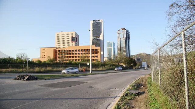 Modern hospital building with high-rise skyscrapers and city skyline in the background, Monterrey, Mexico.