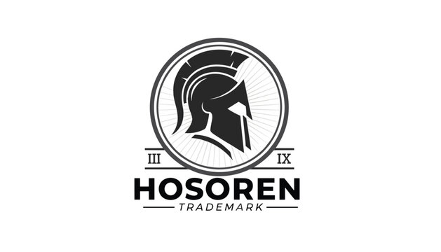 Bold circular logo design featuring a black Spartan helmet silhouette on a light ray background with industrial border details.