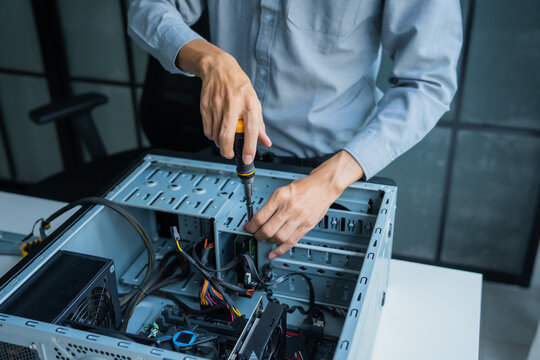 Asian IT engineer using screwdriver fix pc case