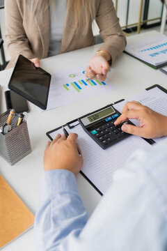 Asian businesswoman showing information on tablet