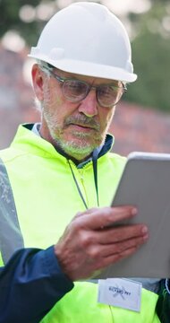 Tablet, man and scroll on construction site for architect, management and property development. Tech, reading and mature civil engineer with inspection for maintenance safety, repairs or renovation