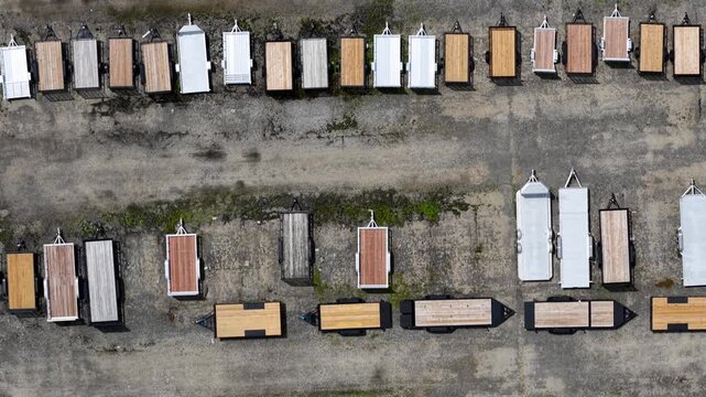Aerial drone flying over a large parking lot full of trailers