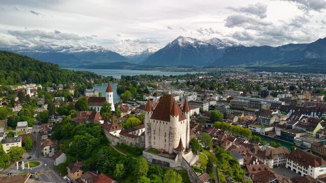 Thun Castle overlooking the historic town and snow capped alps