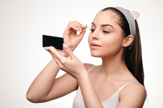 Brunette Woman Applying Eyelash Extensions