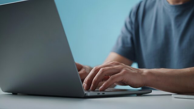 Closeup of a persons hands typing on a laptop keyboard, focusing on productivity and digital communication in a modern workspace
