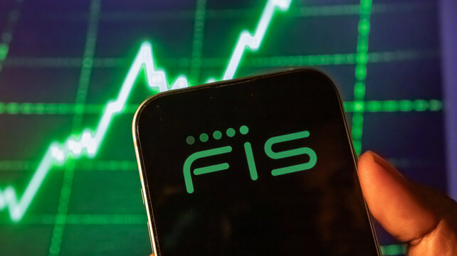 Fis logo on smartphone screen at night with bright green financial trading graph in blurred background dark.
