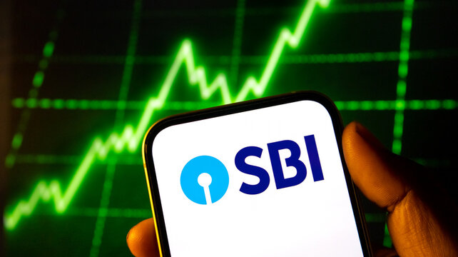 Sbi logo on mobile phone screen with green financial chart background representing banking sector growth now.