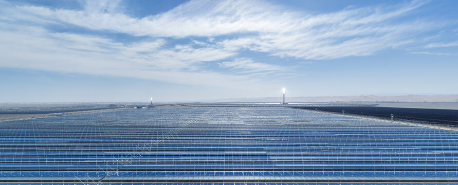 Aerial Panorama of Linear Fresnel Solar Mirrors with Two Glowing Molten Salt Towers in Gobi Desert
