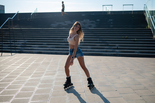 Young woman enjoying rollerblading in urban setting