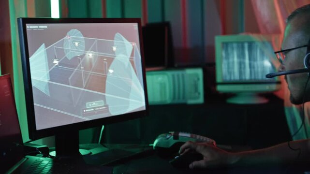 Male hacker with a headset disabling a security camera system in a dark, neon-lit hideout
