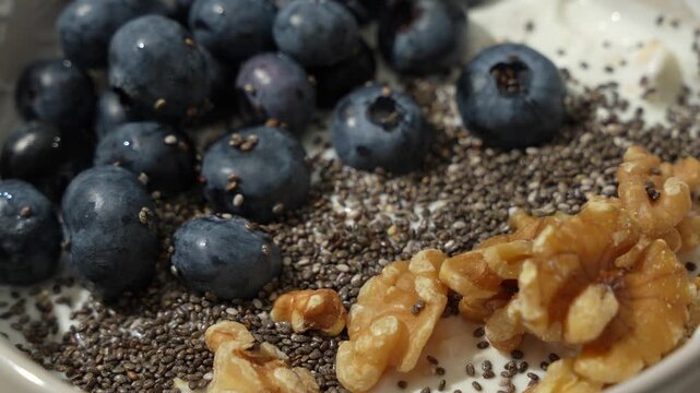 Rotating Skyr Breakfast Bowl with Blueberries, Chia Seeds and Walnuts