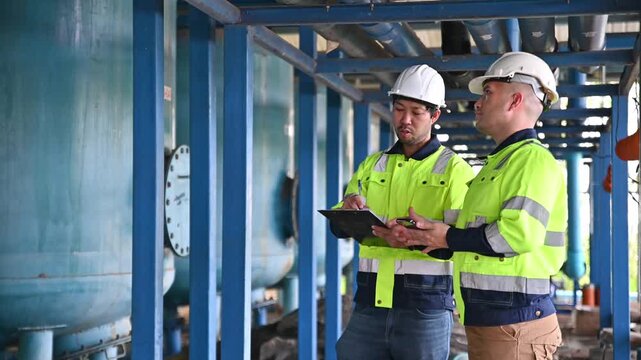 Expert engineers are working together to inspect the structure of the water treatment plant's pipes to ensure they are safe and meet standards.