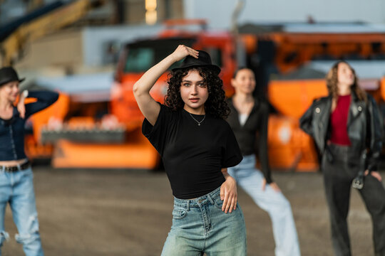 Stylish young woman posing with her dance crew