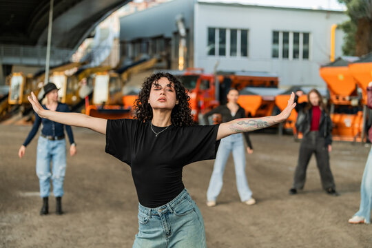 Expressive woman dancing with arms outstretched