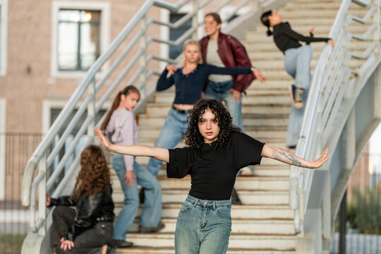 Diverse female dancers posing on an urban staircase