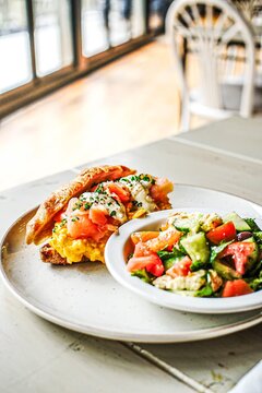 Smoked salmon and egg croissant with a side salad