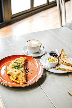 Omelette and cappuccino breakfast on a table