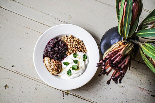 Yogurt bowl with granola berry compote and mint
