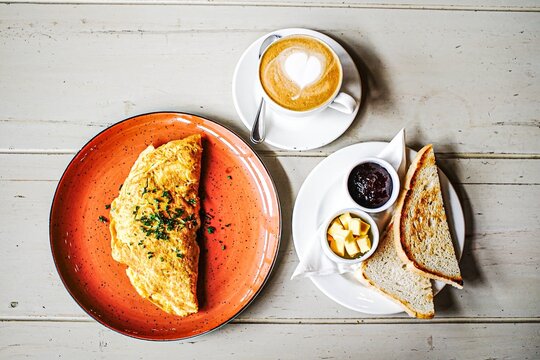 Omelette breakfast with coffee latte art and toast