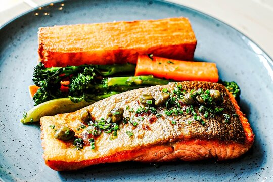 Pan seared salmon fillet with crispy skin and vegetables