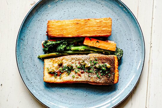 Seared salmon fillet with potato pave and greens