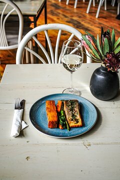 Gourmet salmon lunch with white wine on a restaurant table