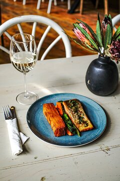 Gourmet salmon dinner with white wine on rustic table