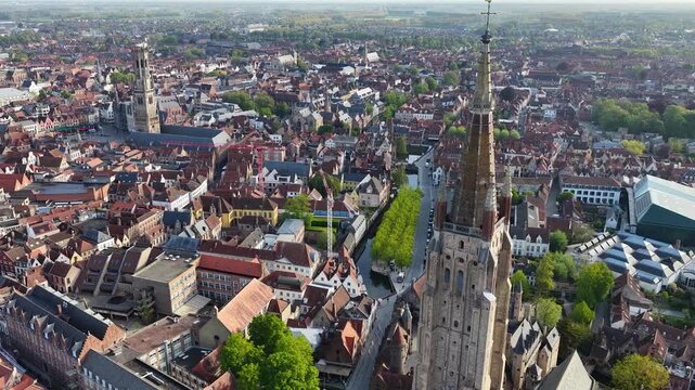 Aerial drone view of the old town of Bruges in Belgium, with the towers of the cathedrals of St. Salvator and St. Mary and the Belfry of the Market square in Bruges. Architecture of the medieval city.