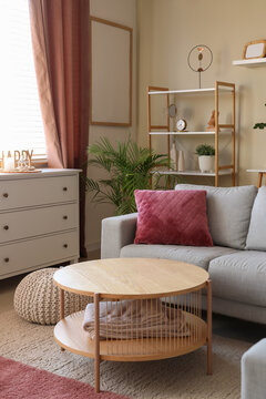 Interior of living room with sofa, drawers and curtains on window