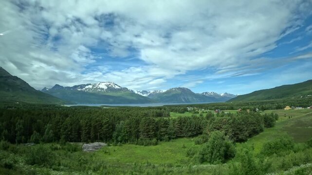 Driving side window view of Narvik and Tromso E6 road sign in Northern Norway