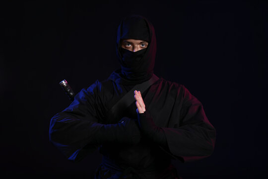 Male ninja on black background