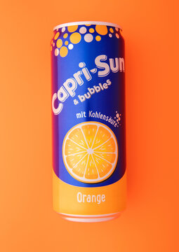 LONDON,UK - NOVEMBER 16, 2025: Original Capri Sun orange soda soft drink juice on orange background.