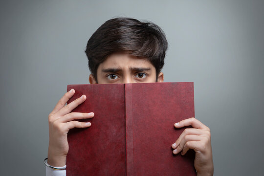 Portrait of a young boy holding a book in hand (Children) 