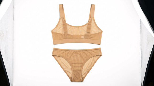 Elegant beige women's two-piece swimsuit set on white background.