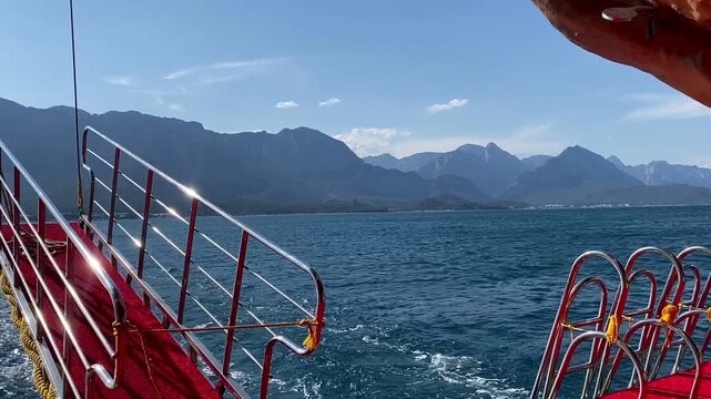 View of the Taurus mountain range. The Mediterranean Sea in Kemer, Turkey. View from a ship in the open sea. Seascape. Blue water.	