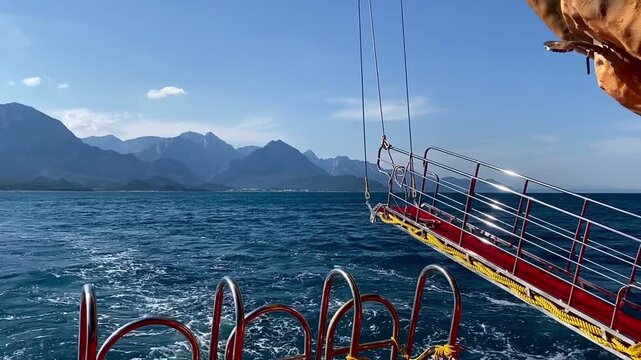 View of the Taurus mountain range. The Mediterranean Sea in Kemer, Turkey. View from a ship in the open sea. Seascape. Blue water.	