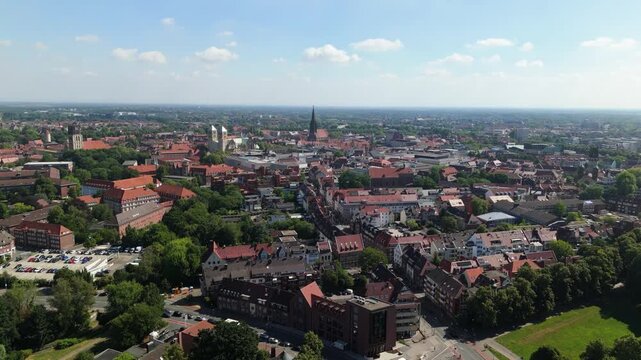 4K Drone flight over M&uuml;nster skyline, Germany, showing St. Paulus Dom, Lamberti Church and historic rooftops.