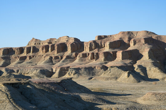 Layered Mudstone and Sandstone Hills in Arid Desert Landscape

