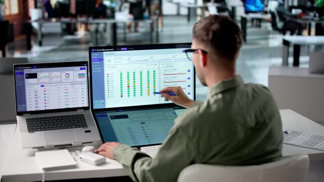 IT Manager Reviews Asset Inventory On Laptop