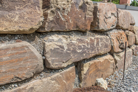 Brick wall of natural stone Grauwacke, construction site